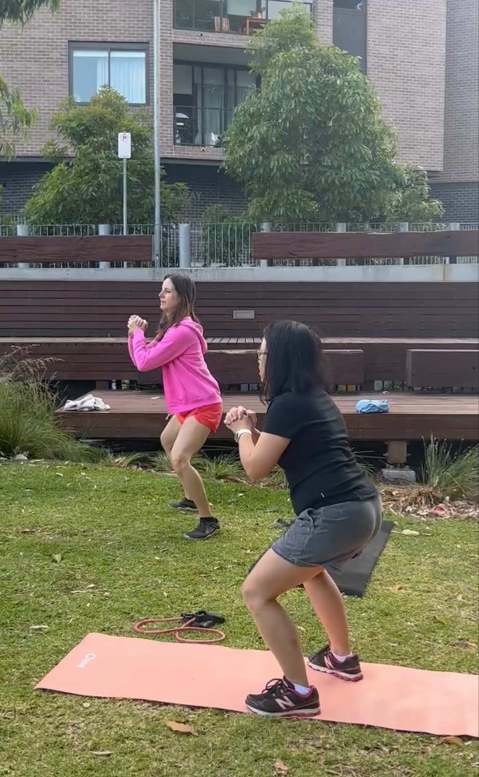 Women exercising in park.